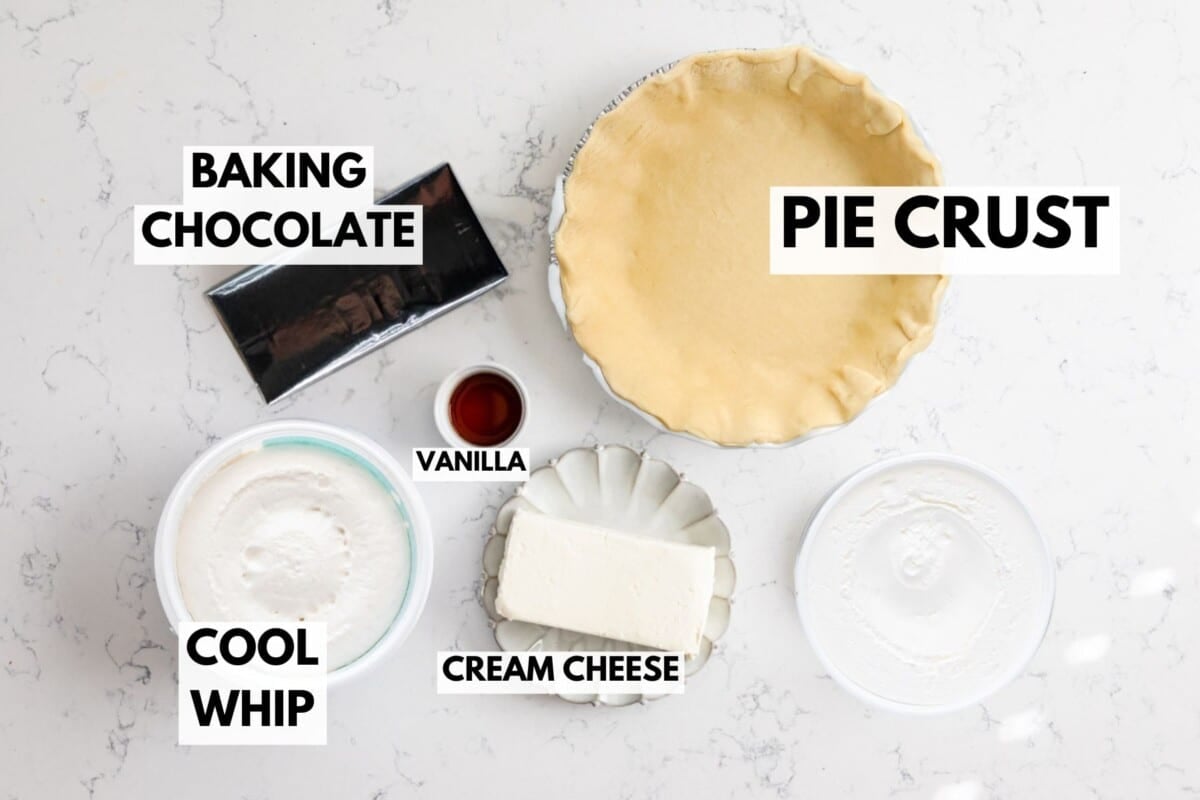 Ingredients for chocolate cream pie on a white surface: a pie crust in a dish, baking chocolate, a small bowl of vanilla, Cool Whip, cream cheese, and sugar. Each item is labeled for easy assembly.