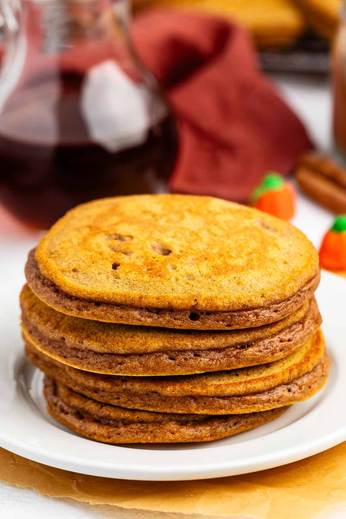 A stack of pumpkin pancakes on a white plate.